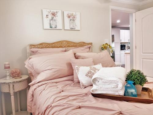 a bedroom with a bed with pink sheets and pillows at FUN! PoolLake near Disney Fast WiFi Pickleball in Clermont