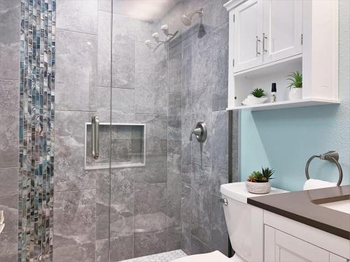 a bathroom with a shower with a glass door at FUN! PoolLake near Disney Fast WiFi Pickleball in Clermont