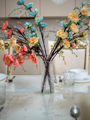 a vase with flowers in it on a table at Smart Lux 320 in Almaty