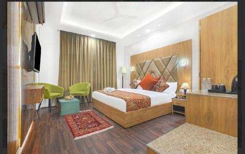 a hotel room with a bed and a table and chairs at Hotel Seven Hill Star in Srinagar
