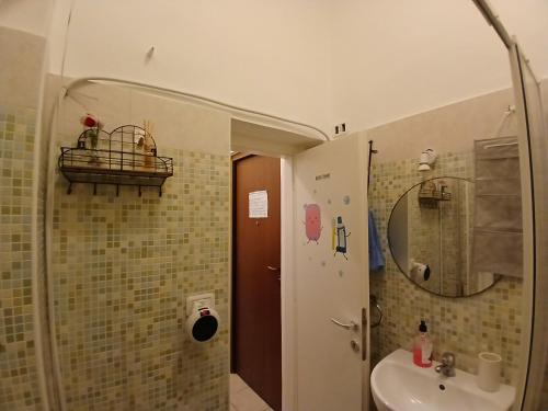 a bathroom with a sink and a toilet and a mirror at La Casina di Giannina in Grosseto