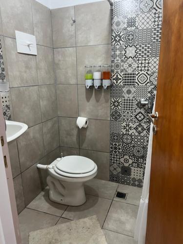a bathroom with a toilet and a sink at Kallpa in Santa Rosa