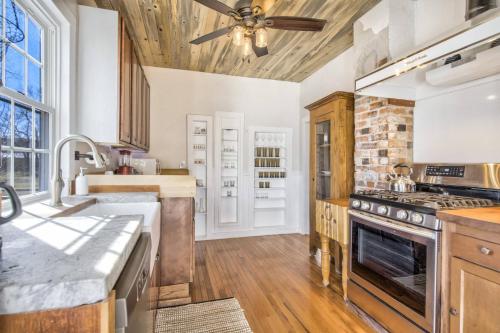 a kitchen with a stove and a ceiling fan at Brewster's Farm in Florence