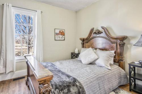 a bedroom with a large bed and a window at Brewster's Farm in Florence