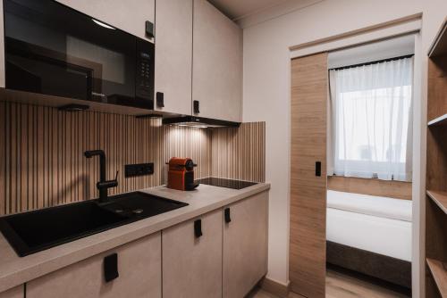 a kitchen with a sink and a microwave at Appartement Sport Steger in Saalbach-Hinterglemm
