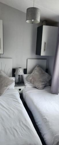 two beds sitting next to each other in a bedroom at Trecco Bay Private rentals in Newton