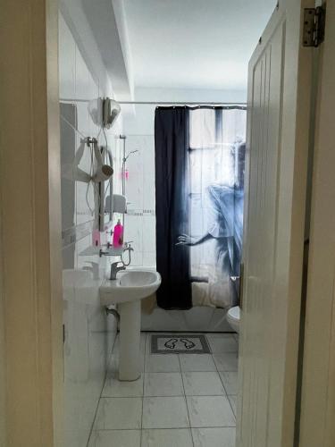 a bathroom with a sink and a shower curtain at Rix Hostel Oda Kiralama, Ortak Banyo Mutfak in Kyrenia