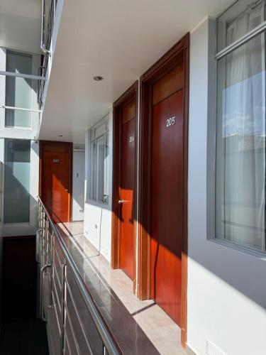 a row of wooden doors in a building at Hotel Luz de Luna in Atico
