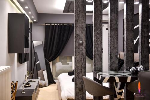 a room with a glass table and a bed at LuxRoom in Patra