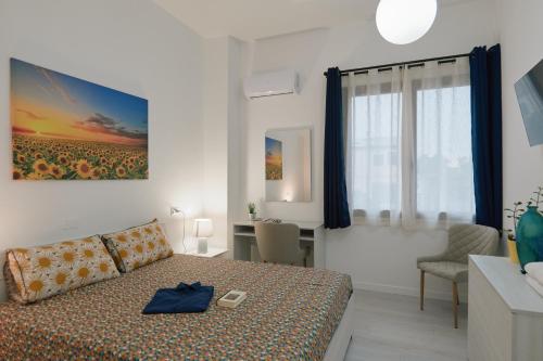 a bedroom with a bed and a living room at Affittacamere La Violica in Villacidro