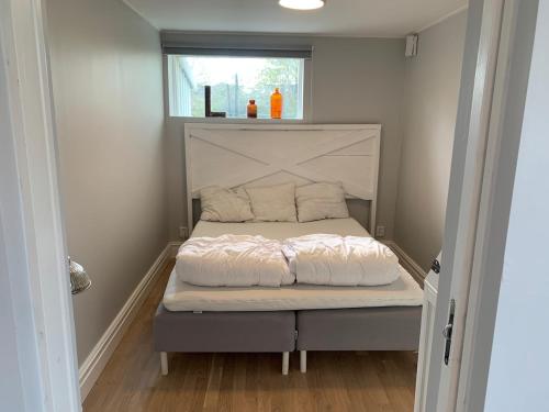 a bed in a small room with a window at Central guesthouse in Halmstad