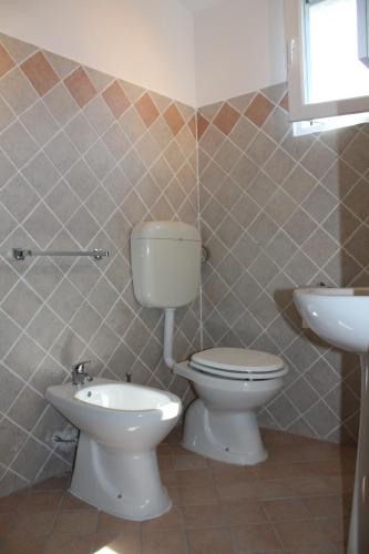 a bathroom with a toilet and a sink at Bungalow Gambaro in Cavallino-Treporti