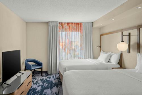 a hotel room with two beds and a television at Fairfield Inn and Suites by Marriott Marion in Marion