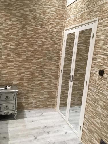 a sliding glass door in a room with a brick wall at Gazalle Oasis in El Biar