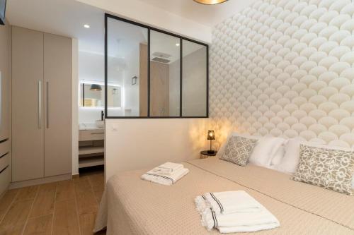 a bedroom with a bed with two towels on it at Paradise luxury White Beach in Paea