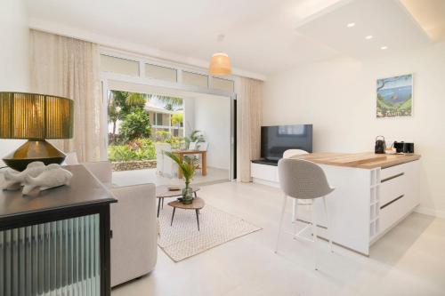 a kitchen and living room with a table and chairs at Paradise luxury White Beach in Paea