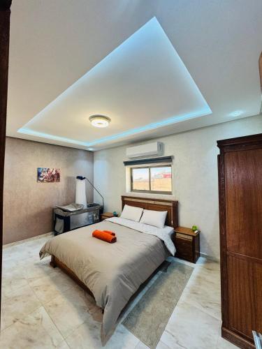 a bedroom with a bed with an orange pillow on it at The Sun Gate in Agadir
