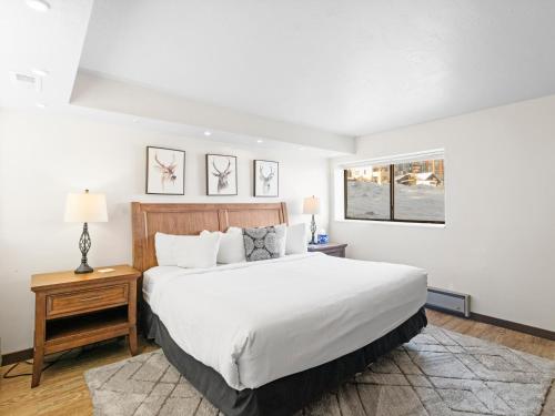 a bedroom with a large white bed and a window at Red Pine Condominiums by All Seasons Resort Lodging in Park City