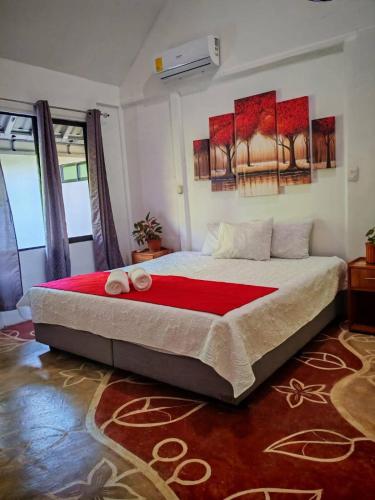 a bedroom with a large bed in a room at Mystic Solarium Private Indoor Pool in Chachagua