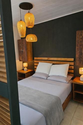 a bedroom with two beds and two lamps at Casita Don Marco in Bocas Town