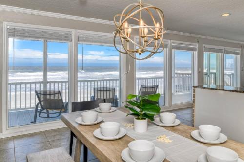 a dining room with a table with a view of the ocean at High Tide Paradise in St. Augustine