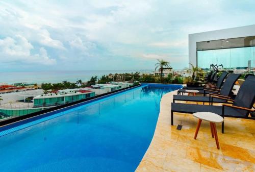 a swimming pool on top of a building at Central Studio - Rooftop Pool Gym Near Beach in Playa del Carmen