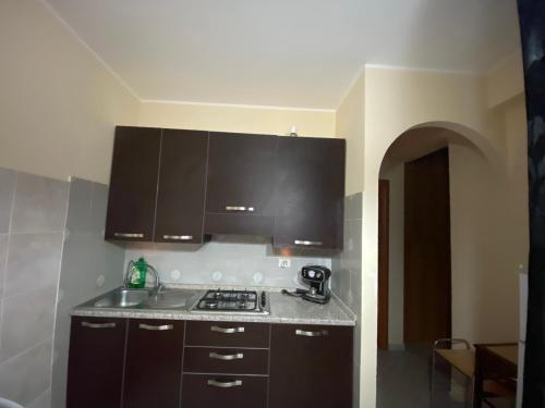 a kitchen with black cabinets and a counter top at Appartamento MiMoSa Scalea in Scalea