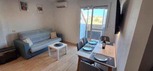 a small living room with a couch and a table at A & G Sabinillas in San Luis de Sabinillas