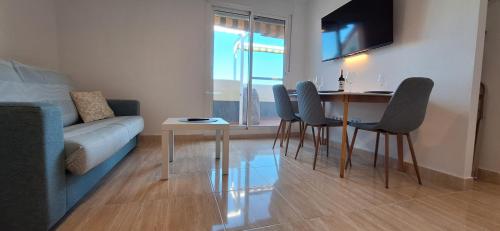 a living room with a table and chairs and a couch at A & G Sabinillas in San Luis de Sabinillas