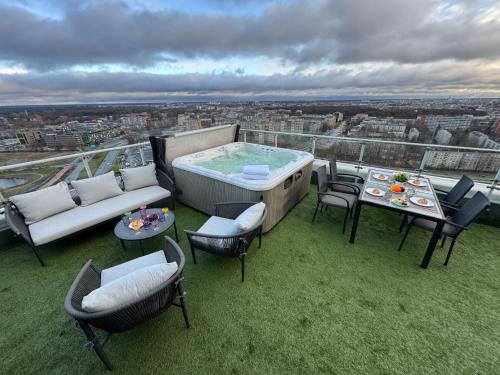 a hot tub sitting on top of a building at Grand Penthouse And SPA in Riga