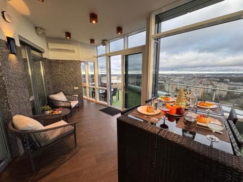 a dining room with a table with food on it at Grand Penthouse And SPA in Riga