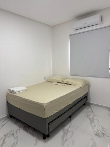 a bedroom with a bed in a white room at CASA MARECHAL FRANCÊs in Marechal Deodoro