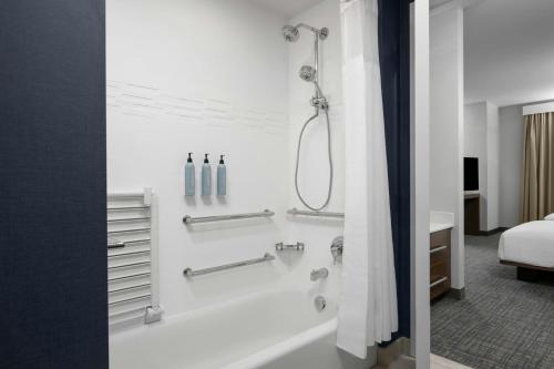a bathroom with a shower and a bath tub at Residence Inn by Marriott St. George in Washington