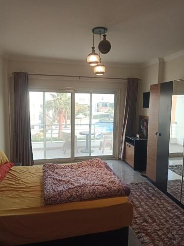 a bedroom with a bed and a view of a patio at Sky Star Villa 97 in Hurghada