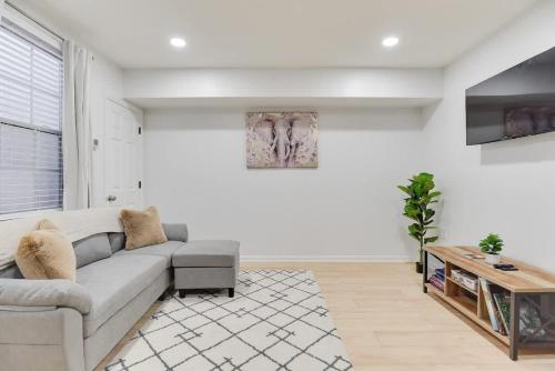 a living room with a couch and a table at Stylish 2BR Near Union Market & Metro in Washington, D.C.