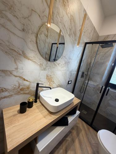 a bathroom with a sink and a shower at Casa Amore Design - South Sardinia - in San Gavino Monreale