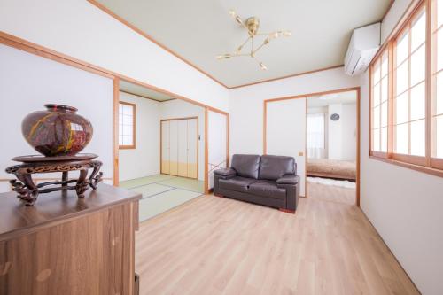 a living room with a chair and a table at Genkido-Private House in Takasaki