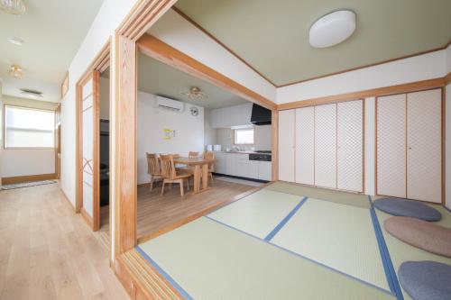a living room with a table and a dining room at Genkido-Private House in Takasaki