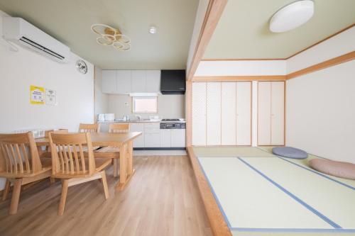 a kitchen and dining room with a table and chairs at Genkido-Private House in Takasaki