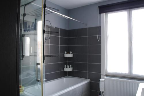 a bathroom with a tub and a glass shower at Casa Seblina in Ostend