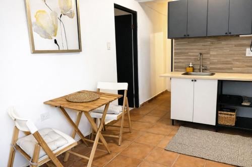 a kitchen with a table and chairs and a sink at Spacious Studio in San Juan