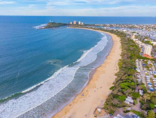 an aerial view of a beach and the ocean at The Mooloolaba Gallery in Mooloolaba