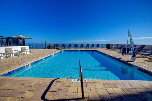 a swimming pool with a view of the ocean at La Bella Inn - POOL OPEN in Daytona Beach
