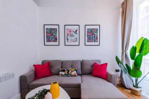 a living room with a couch and pink pillows at Parliament St Apt 2 - Central Hull - Sleeps 4 in Hull