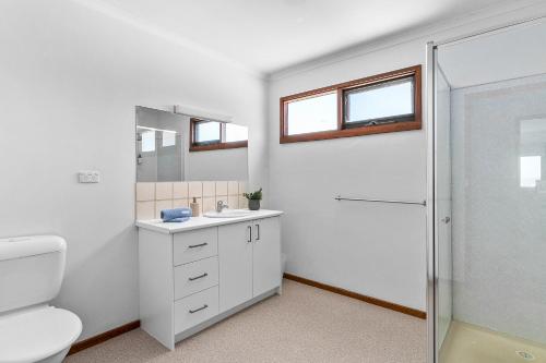 a bathroom with a toilet and a sink and a shower at River Meets Ocean Edge - Absolute Waterfront in Barwon Heads