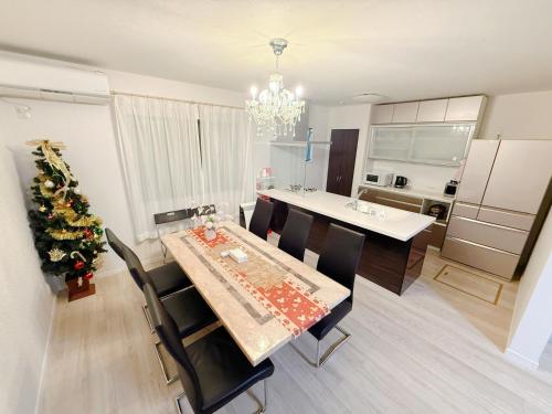 a kitchen and dining room with a table and a christmas tree at Free Parking Namba south Villa 4 rooms 120m2 in Osaka
