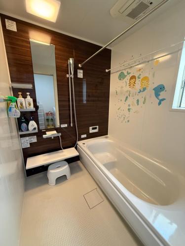a bathroom with a tub and a sink and a mirror at Free Parking Namba south Villa 4 rooms 120m2 in Osaka