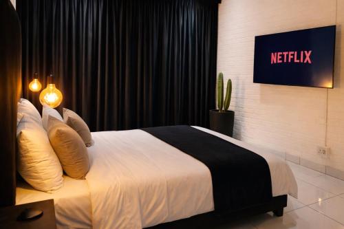 a bedroom with a bed with a sign on the wall at Industrial CHIC Apartment 113 - Luxury City Escape, Washing Machine & Fast WiFi in Johannesburg