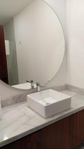 a bathroom with a white sink and a mirror at Perfect location 2 bedrooms Romantic Zone PV 601 in Puerto Vallarta