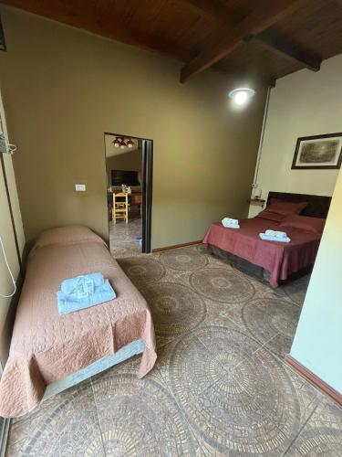 a room with two beds and a mirror at Maranatha in Rufino